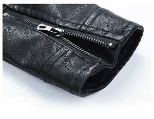 Detailed macro view of black faux leather jacket cuff with metal zipper and fine grain