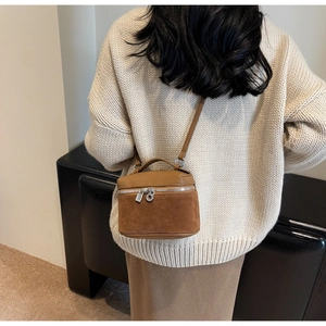 Detail of vintage brown leather vanity case with silver lock and crossbody strap style