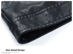 Detailed macro view of the double-stitched hem on a black leather motorcycle jacket