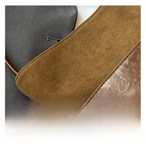 Detail of premium brown pebble leather and yellow suede stitching with neat seam lines
