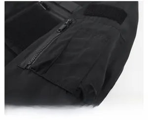 Detail of bomber jacket sleeve featuring utility zipper pocket and pen slots on nylon fabric