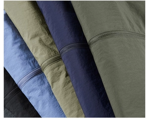 Macro detail of waterproof jacket fabrics in multiple colors with high-quality zippers