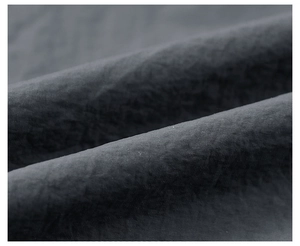 Macro shot of charcoal grey functional textile fabric texture with matte finish and subtle folds