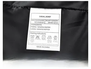 Detail of the internal wash care label on a black bomber jacket showing 100% polyester