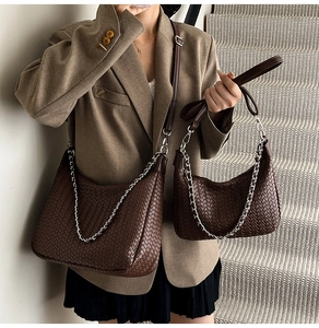 Detail view of woven leather handbag combo with silver chain strap on model