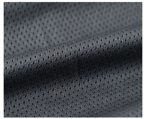 Macro shot of breathable dark grey mesh fabric with honeycomb texture for men's jacket