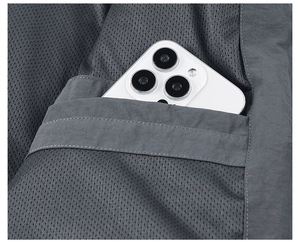 Macro view of interior breathable mesh lining and secure inner pocket on men's jacket