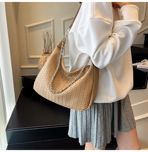 Hobo shoulder bag with woven leather texture and silver chain strap detail in camel color