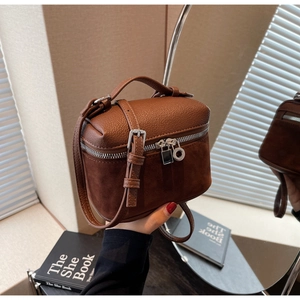 Detail of vintage brown textured leather and suede mini box bag with silver hardware