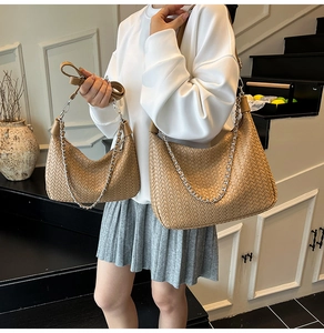 Detail of woven leather crossbody bag in khaki with silver chain and leather strap