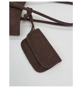Close-up of the vintage pleated dark brown leather mini pouch and cord texture detail