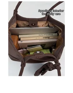 Spacious interior of dark brown soft leather tote bag showing laptop and daily essentials