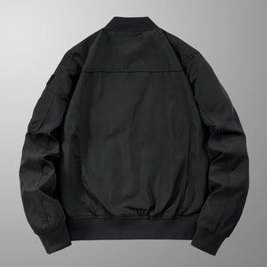 Men's black tactical bomber jacket featuring a utility sleeve pocket and ribbed hem