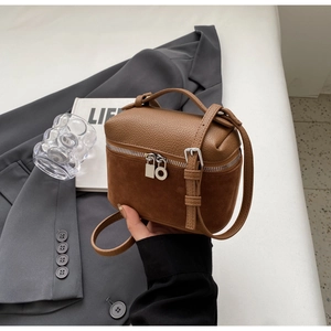 Detail of vintage brown mini box bag showing contrast textures of leather and suede finish