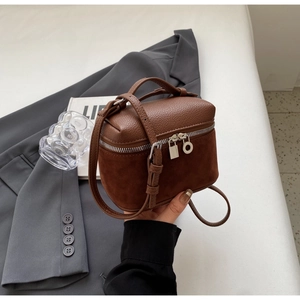 Detailed shot of brown mixed-texture mini box bag with silver hardware and top handle