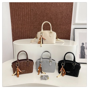 Selection of leopard print boston bags with beaded charms and adjustable straps