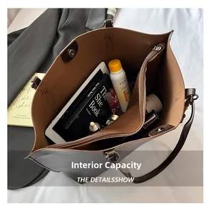 Internal view of brown faux leather tote bag showing spacious capacity for daily items