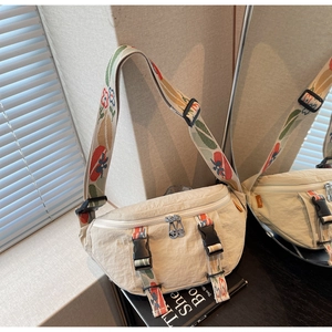 Detail of light beige nylon chest bag with colorful floral jacquard woven shoulder strap