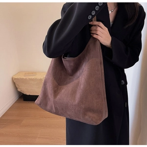 Detailed view of dark brown suede tote bag with matte texture for workplace commute