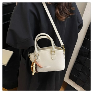 Detail of cream leopard bucket bag with beaded tassel and fashion leather embossing