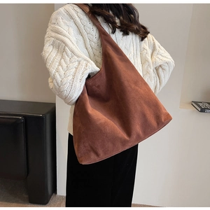 Brown frosted leather hobo bag styled with a white knit sweater for a cozy autumn look