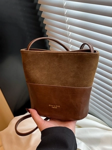 Brown vintage patchwork bucket bag with suede texture and golden logo for women