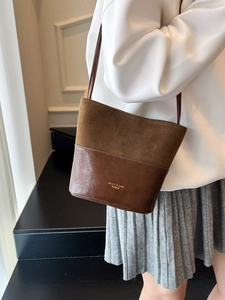 Vintage patchwork leather bucket bag in brown suede for women shown on model