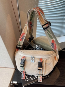 Minimalist beige nylon chest bag with colorful floral jacquard strap and dual zippers