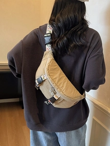 Khaki sports chest bag with floral strap shown worn on model back for casual outdoor style