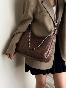 Brown woven leather shoulder bag with metallic chain strap and minimalist design