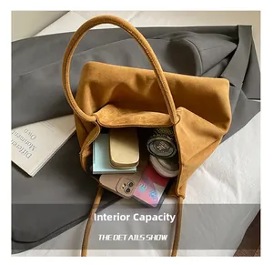 Spacious interior of yellow suede tote bag showing tablet and daily essentials