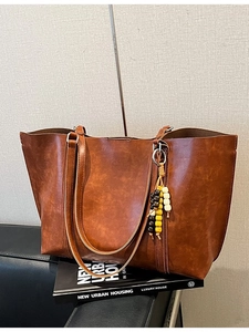Vintage brown large capacity tote bag with leather texture and ethnic beaded pendant