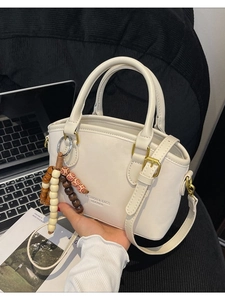Creamy leather leopard print Boston handbag with gold hardware and beaded charm