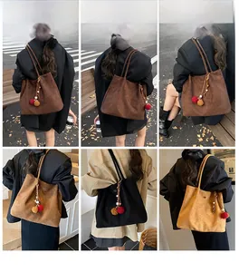 Detail shots of large suede tote bags in various colors with decorative pompom charms