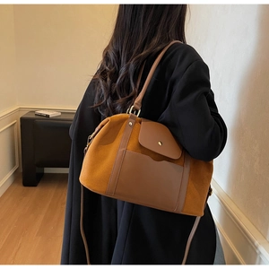 Makroansicht der braunen Wildleder- und Lederstiche an der großen Vintage-Tote-Bag