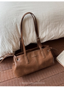 Close-up of vintage brown leather tote bag with Muting hardware and drawstring details