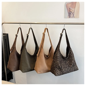 Macro detail of high-quality suede hobo bags in solid colors and leopard print