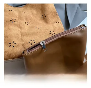Detail of laser-cut star patterns on a brown bucket bag with a matching zip pouch