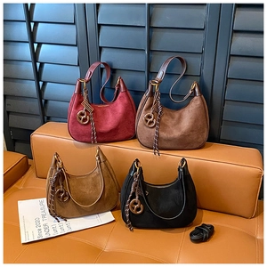 Collection of hobo shoulder bags in suede leather with woven charms and various colors