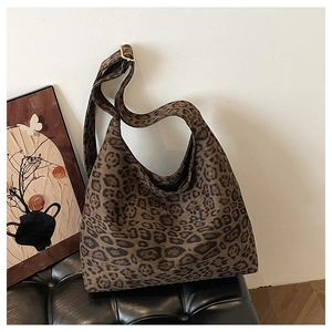 Detail of leopard print suede tote bag with adjustable golden buckle and wide strap