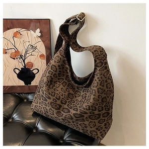Detail of the leopard print faux suede fabric texture and adjustable matte gold hardware