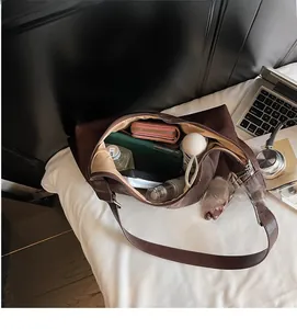 Internal view of a large dark brown tote bag showing spacious capacity for daily items
