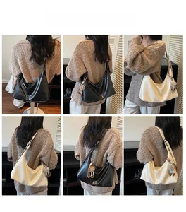 Detail shots of black and cream crescent hobo bags with decorative plush ball charms