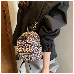 Detail view of mini leopard print backpack with durable canvas and black PU straps for women