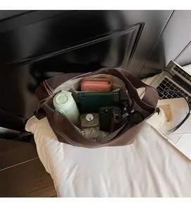 Top view of the interior compartment of a large brown tote bag showing its spacious capacity
