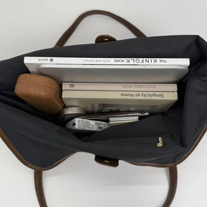 Top view showing large interior capacity of black tote bag for laptops and books