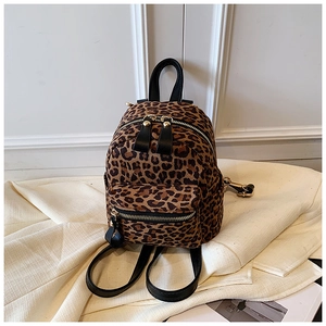 Detail of vintage leopard print backpack with soft fabric texture and gold zippers