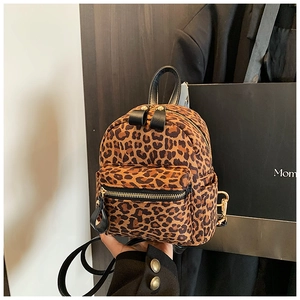 Detail of leopard print mini backpack with soft faux calf hair texture and gold zippers