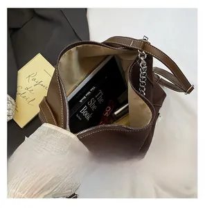 Detail shot of the large capacity interior of the dark brown shoulder bag with zipper