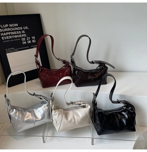 Detail view of glossy faux leather shoulder bags in five colors with star pendant